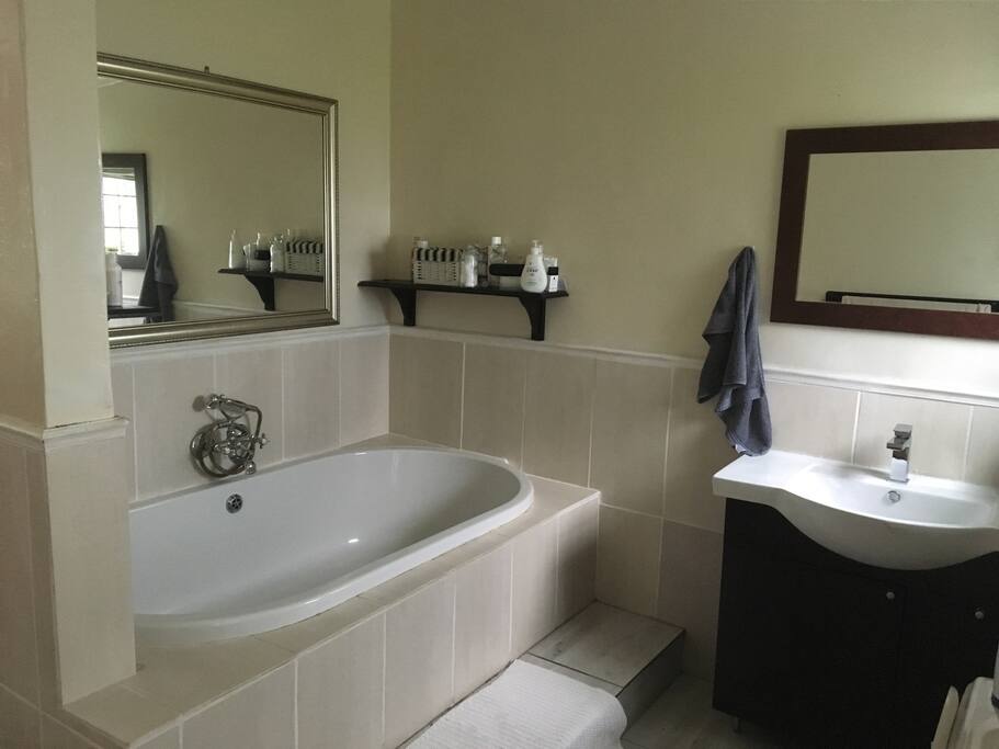 Main bathroom en suite main bedroom. Bath, shower, toilet and wash basin with walk in storage cupboard space