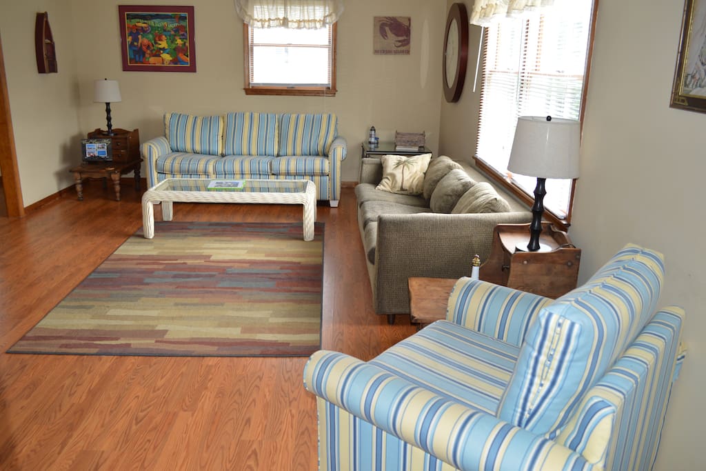 Large spacious living room has sleeper sofa.