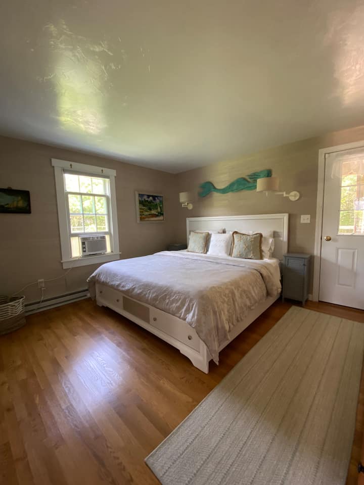 Primary Bedroom with King Bed and access to lower deck and patio with hot tub