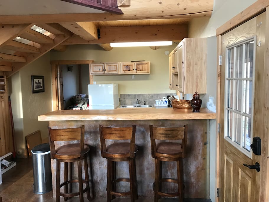 Full kitchen with pots, pans, plates, coffe maker and microwave