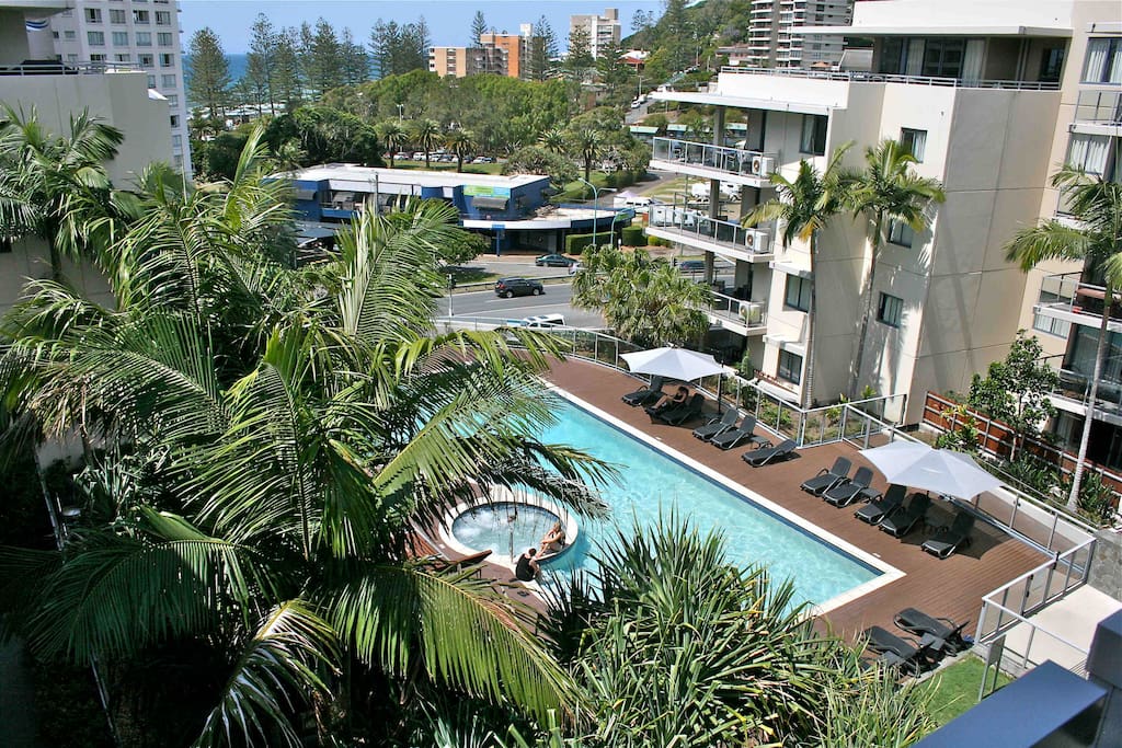 The view from the balcony down to the tropical pool, spa & bbq