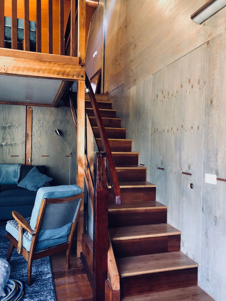 Beautiful staircase leading to sleeping loft made from recycled timbers, some from the MCG.