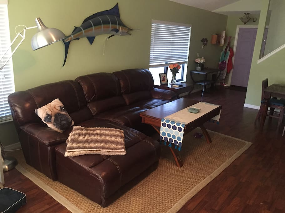 Living room couch facing fire place and TV
