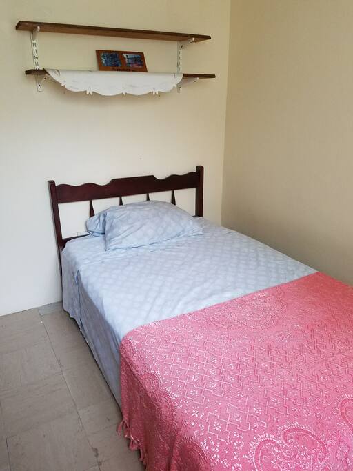 Double bed with closet and sitting chair