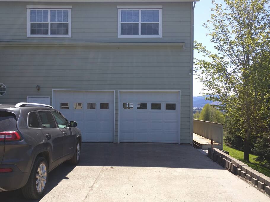 Guest parking area. Right side of our driveway is reserved for you. in the driveway. Easy room for two cars in a row. Also seen is the private entrance, walkway on the right.