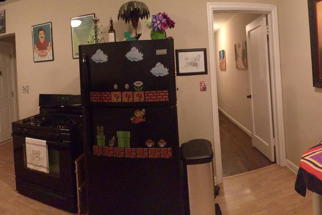 Kitchen with gas stove, fridge, freezer, microwave, toaster, and sink