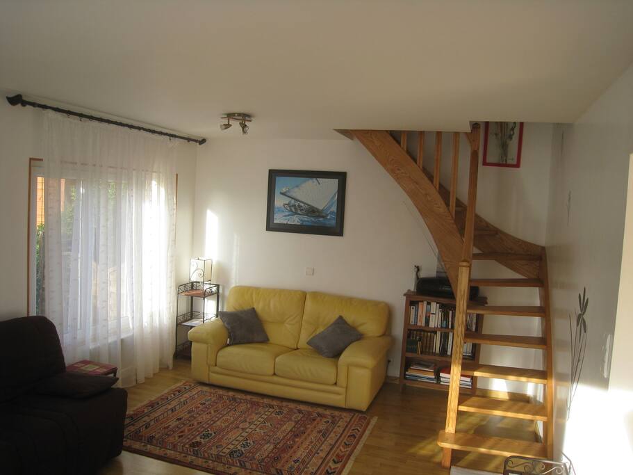 Escalier menant à une petite chambre séparée et un palier avec canapé