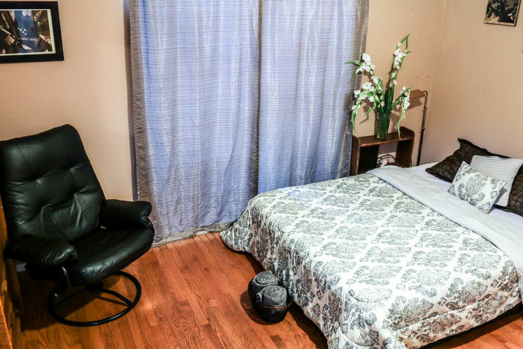 Queen size bed and chair. Dresser and personal fridge are also in this room.