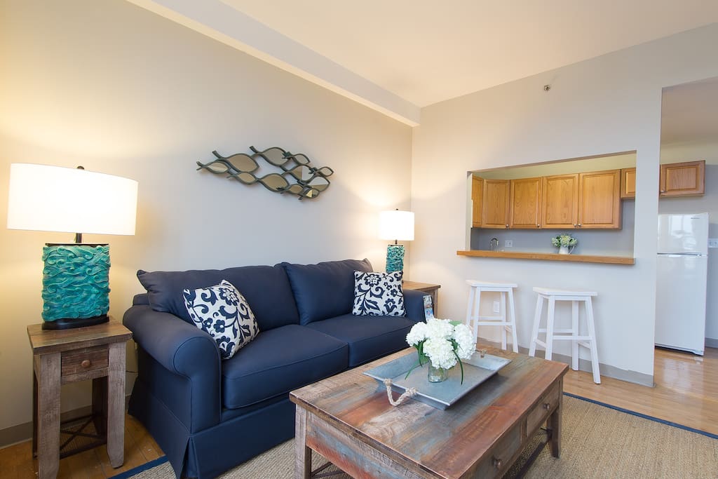 Comfortable couch facing a 55" flat screen TV