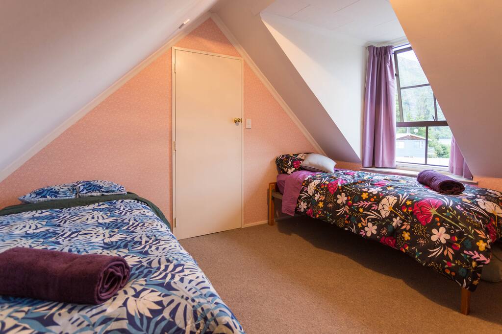 The shared room, two single beds, nice views of the mountains and lake.