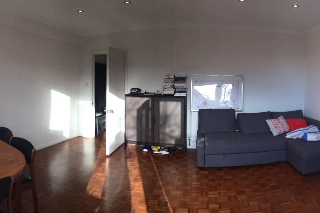 Large and Bright Living Room with a large sofa bed and dining table for 6.