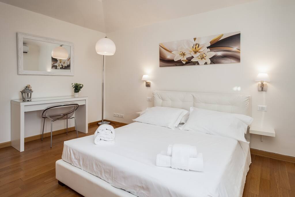 First bedroom with a wardrobe and an amazing view of the top of Spanish Steps , St.Peter's and Quirinal