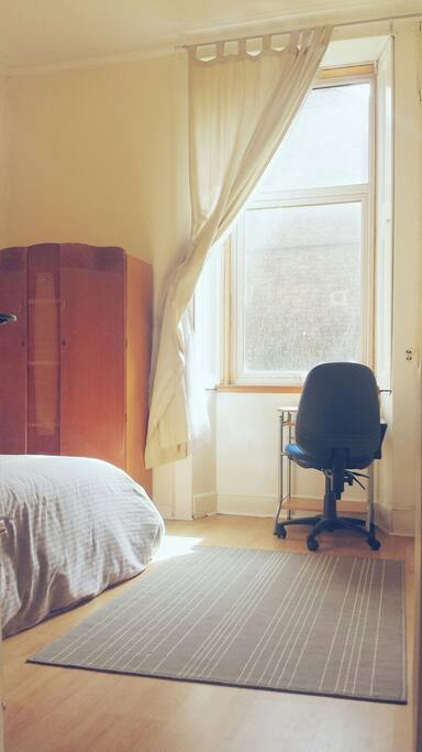 Bedroom wardrobe, desk, double glazed window.