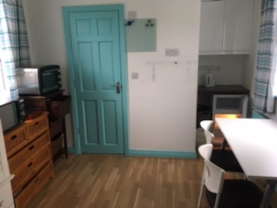 Main room Kitchenette with fridge/freezer, oven microwave, and induction hob.