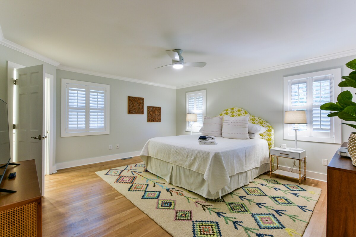 A custom upholstered headboard, soft sheets and king sized pillows top this Cali King bed.  A ceiling fan and 2 bedside lamps, plus a 55” Roku TV ensure you’ll be comfy staying here! 