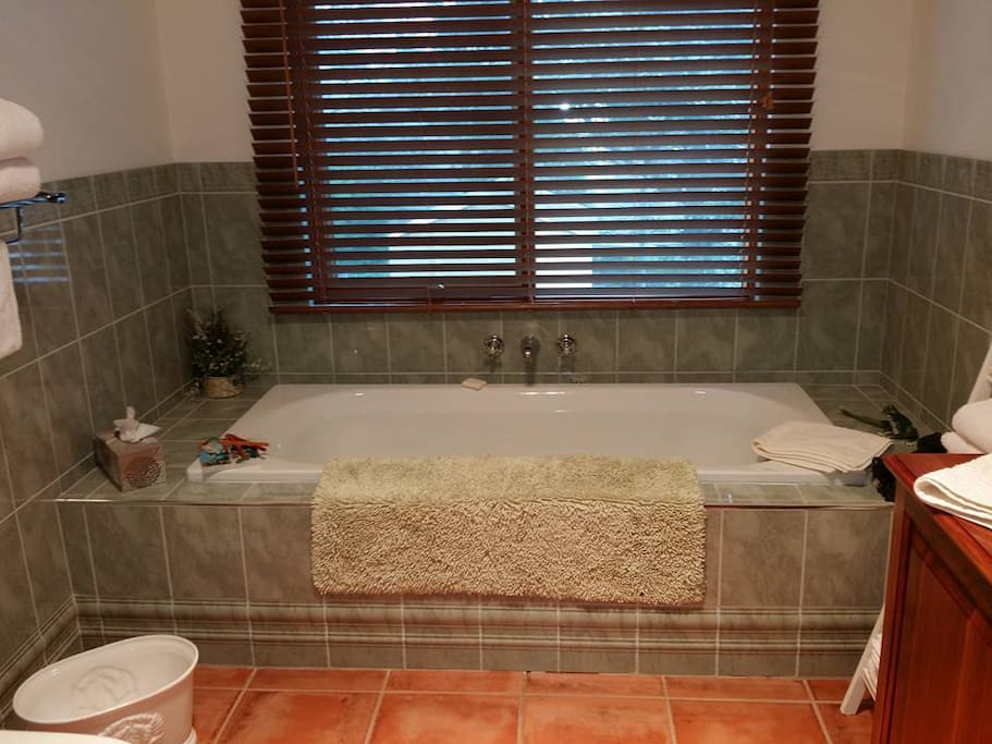 The bathroom has a full size bath as well as shower