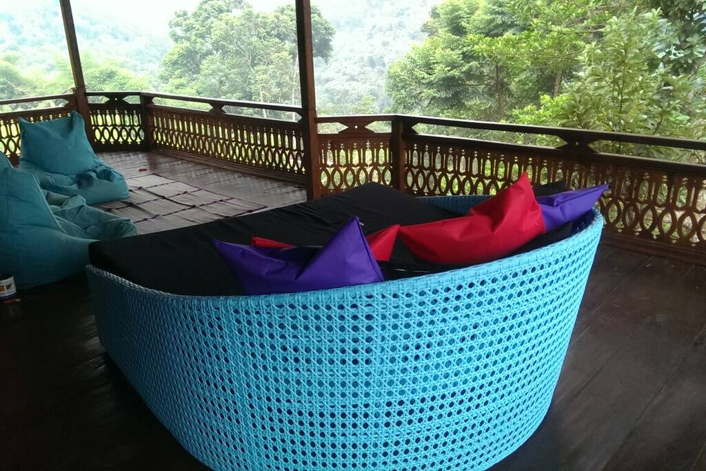 Large wraparound veranda with beanbags and daybed to relax and take in the views