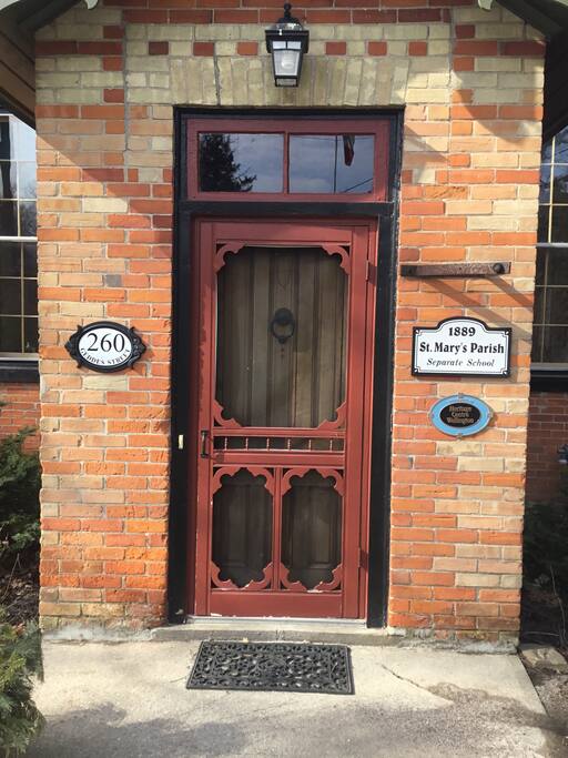 This entrance notes the heritage designation of the 1889 schoolhouse
