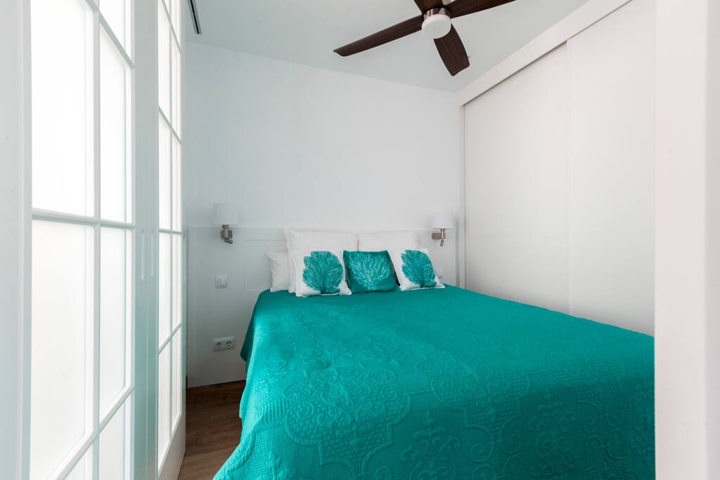 Master bedroom with ample closet space and dressers inside the closets.