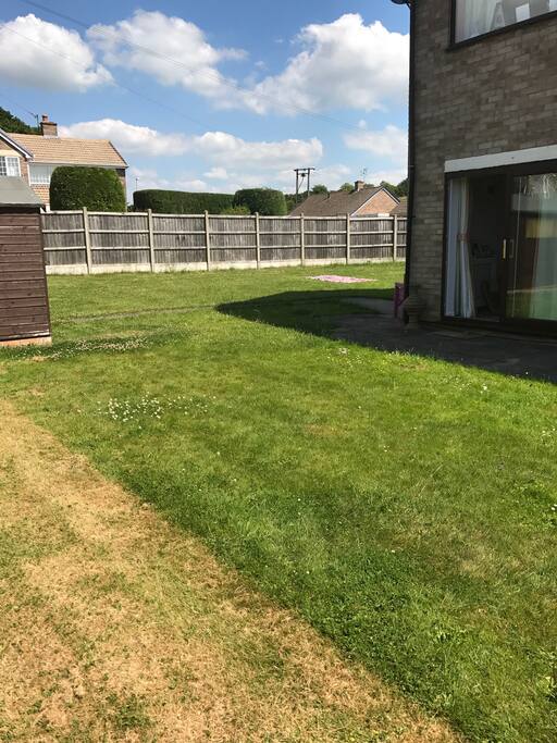 L shaped lawn with trampoline