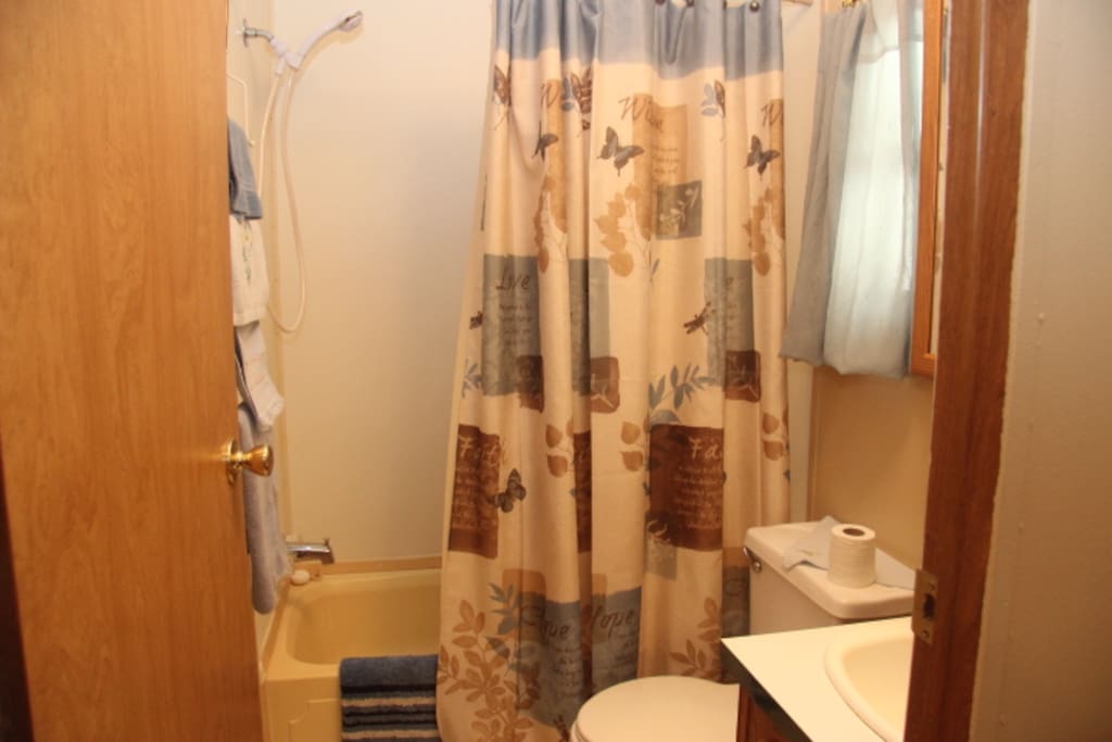 Front bathroom with tub and shower.