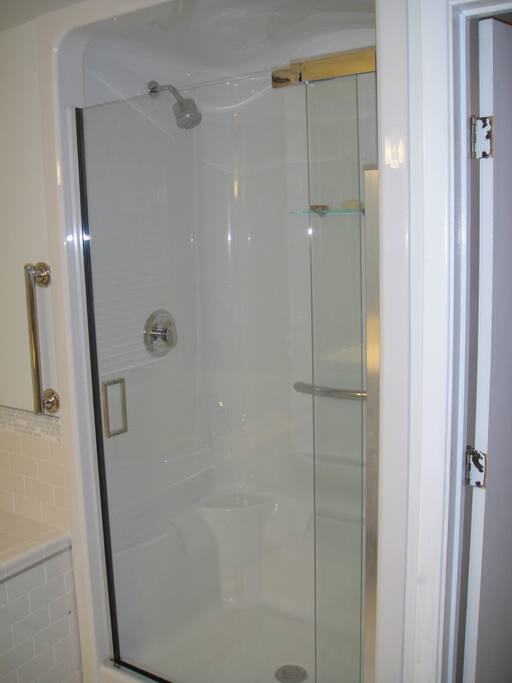 Large shower stall with ample room, even for big and tall guests.