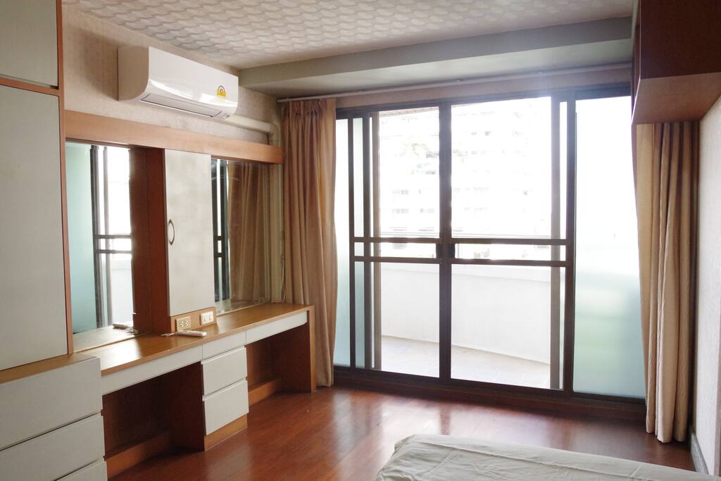 Cozy master bedroom with balcony and swimming pool view.