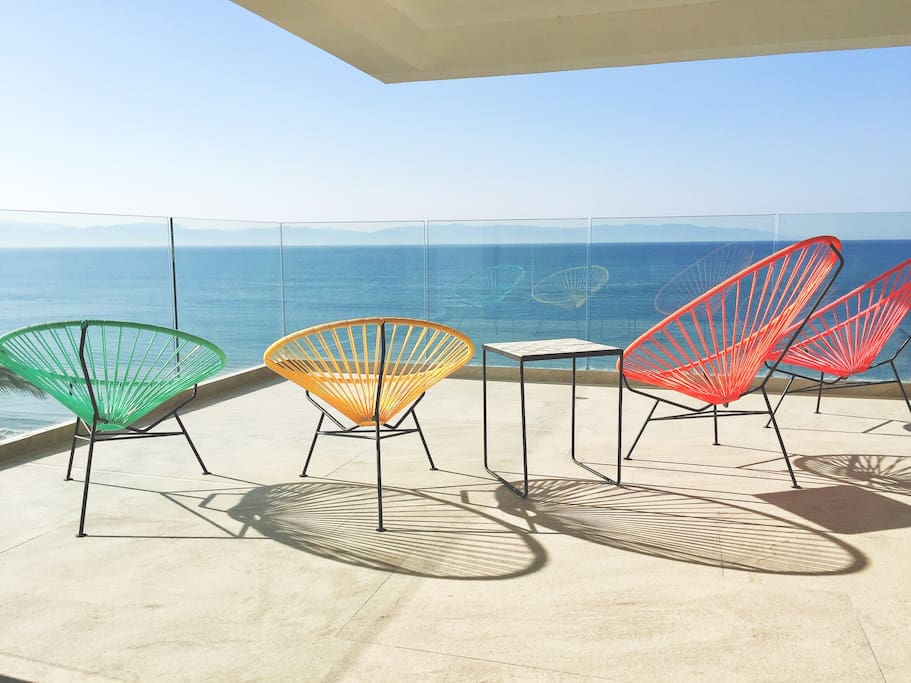 Colorfull Acapulco chairs in condo´s corner private terrace