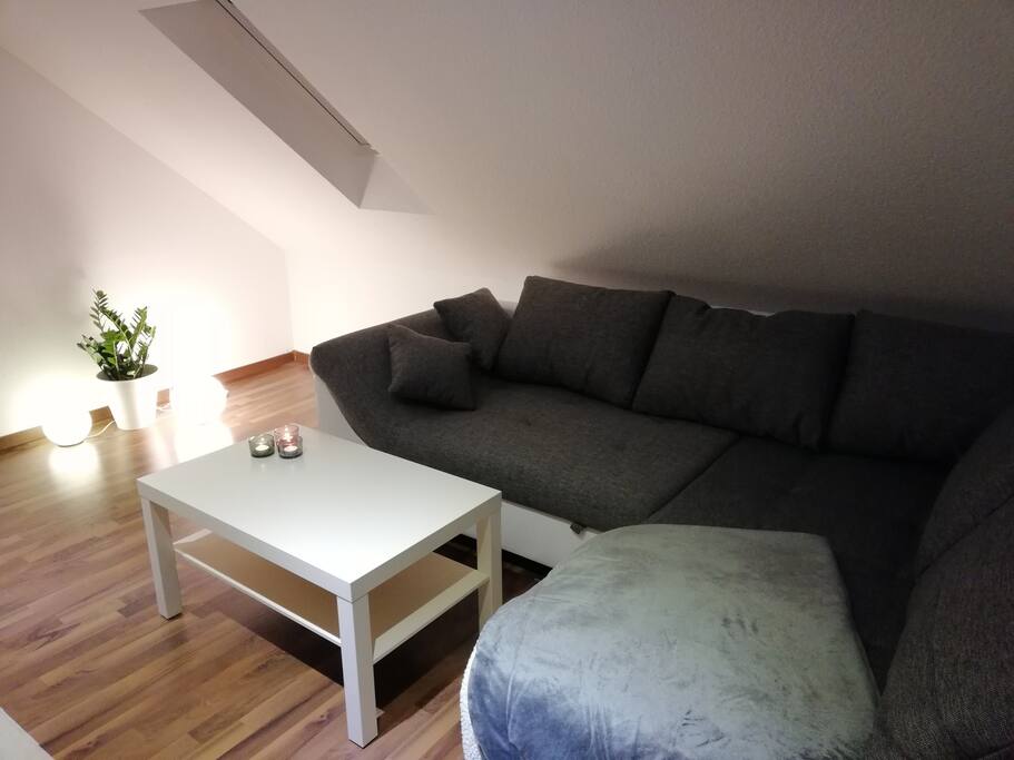 Wohnzimmer mit Schlafcouch und Fußbodenheizung
