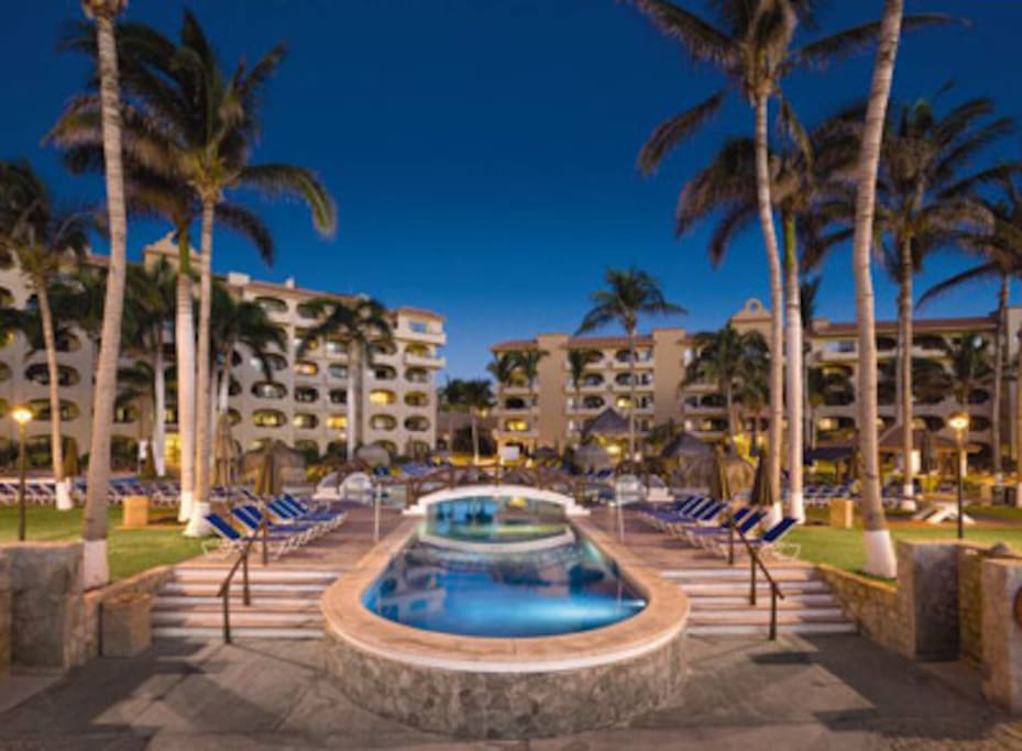 incredible pool complex with a swim-up bar