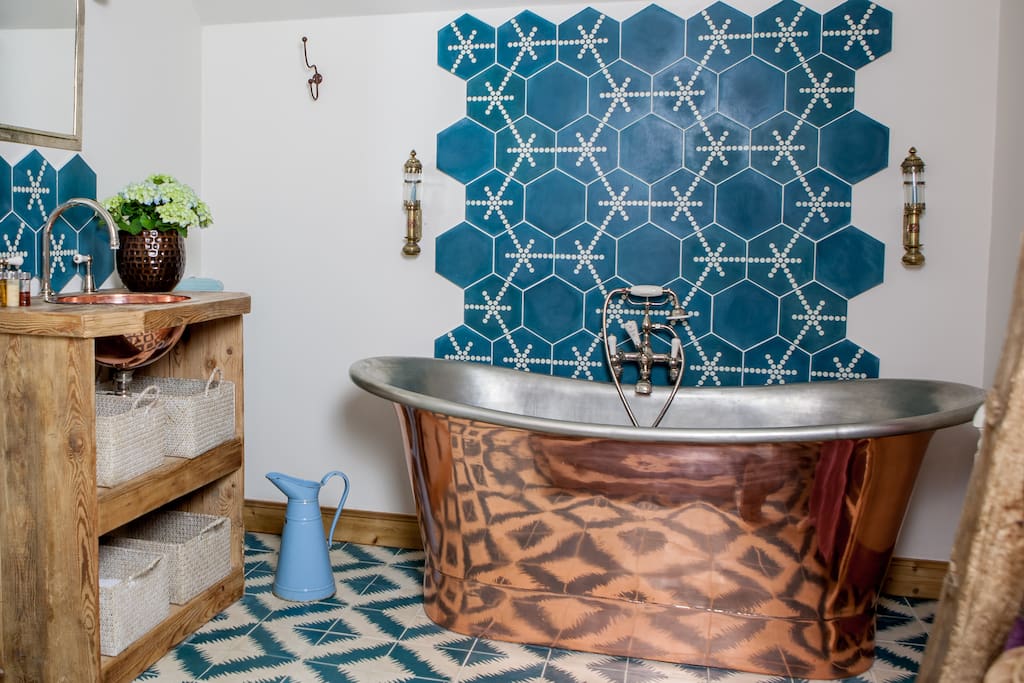 Bathroom One with large copper bath, wc and sink