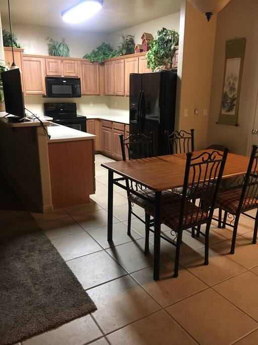 Full kitchen and dining area with all appliances, dishes, and utensils.