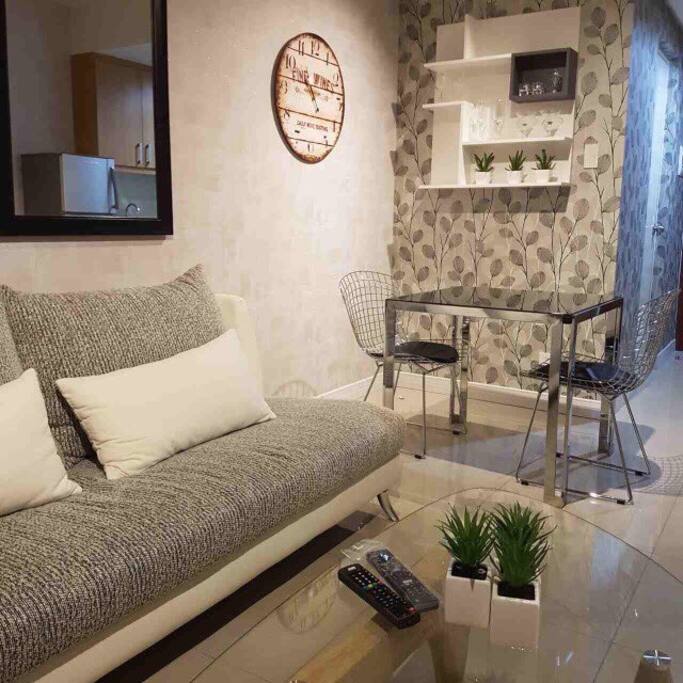 Watch TV from this couch or have something light at this table set