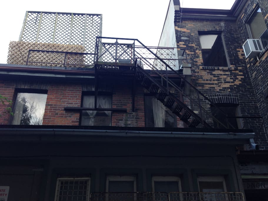 Exterior of the inner courtyard looking up at fire escapes.