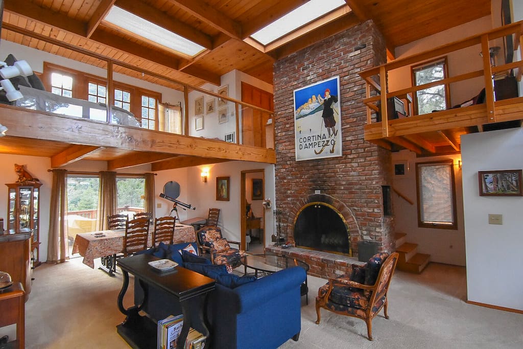 This fireplace goes three stories high! The lower level has a fireplace too. The brick, wood and light are all very lovely!