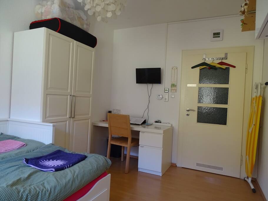 With a wardrobe, TV and desk