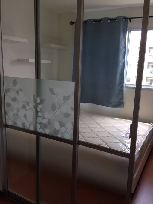 a sliding glass partition between bedroom and living room