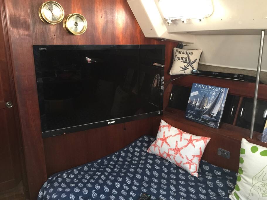 The salon with big screen tv and dvd in entertainment room in between the private staterooms