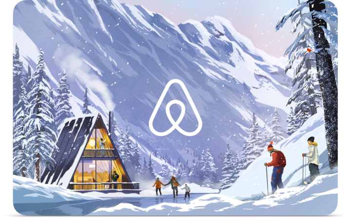 Illustration of bundled-up ice skaters and snowshoers playing in front of a cozy A-frame house. The house is nestled alongside a snowy mountain. The Airbnb logo is in the center.