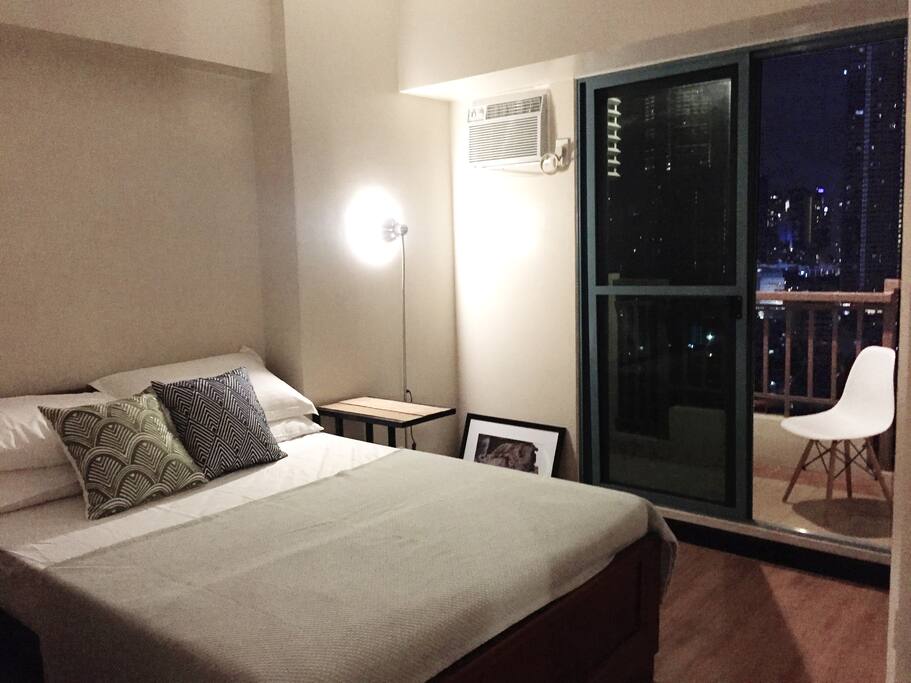Bedroom with balcony. View of Makati City skyline.