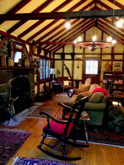 Large living room with rustic stone fireplace