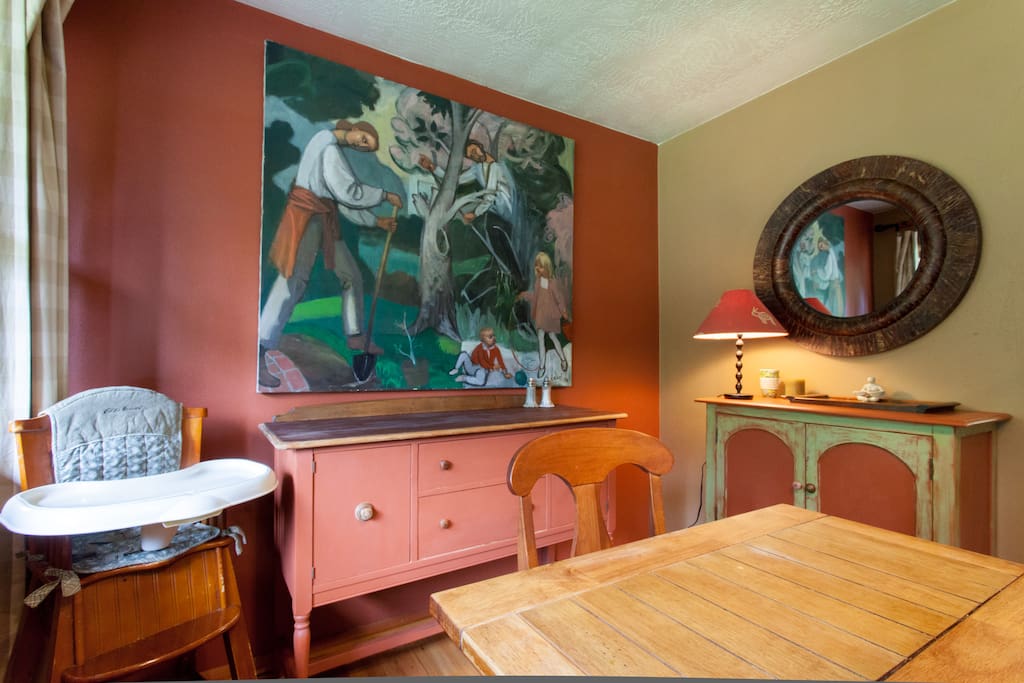 Dining room with highchair and bar...usually has a bit of the hair of the dog that bit you available.