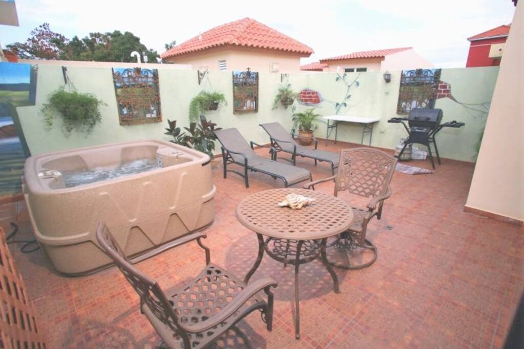 2 private terraces, this one with hot tub, lounge chairs, BBQ