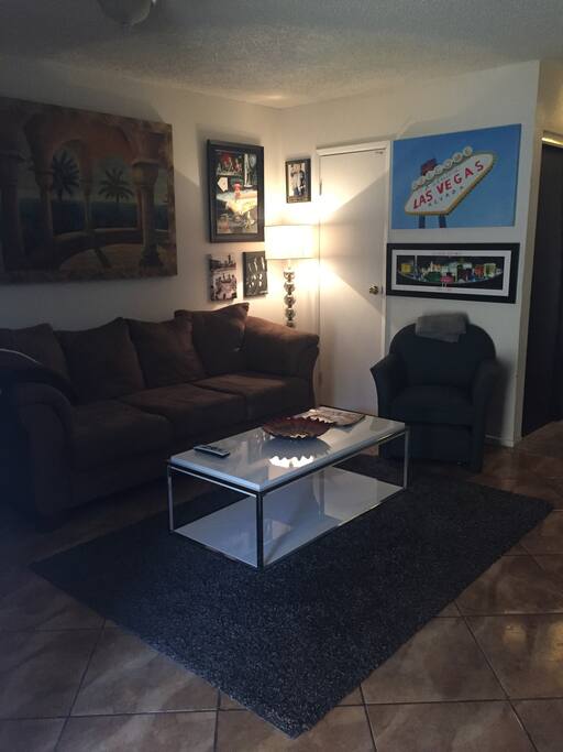 Plush couch with coffee table with all kinds of to do magazines with coupons