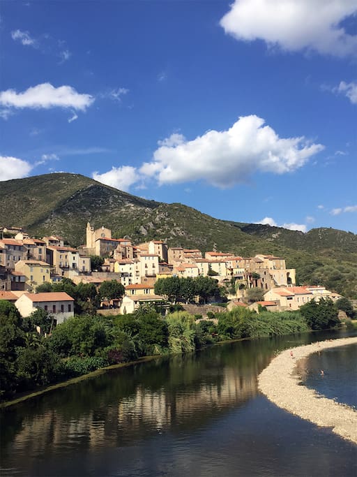 Roquebrun with its popular beach. Our house is located at the top of the village behind the church.