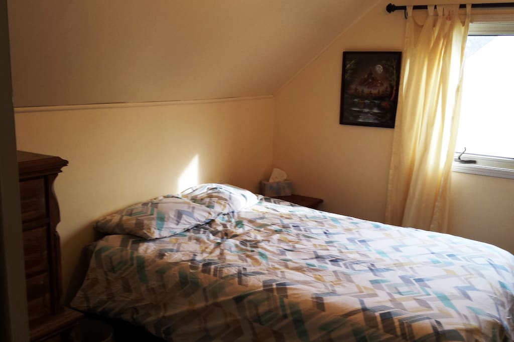 Cozy, bright bedroom with double bed.