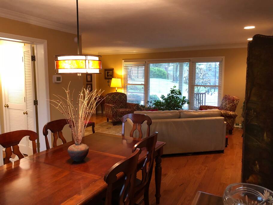Formal living and dining rooms. Black-out blinds in front of picture window allowing for peaceful sleep on the new sofa bed.