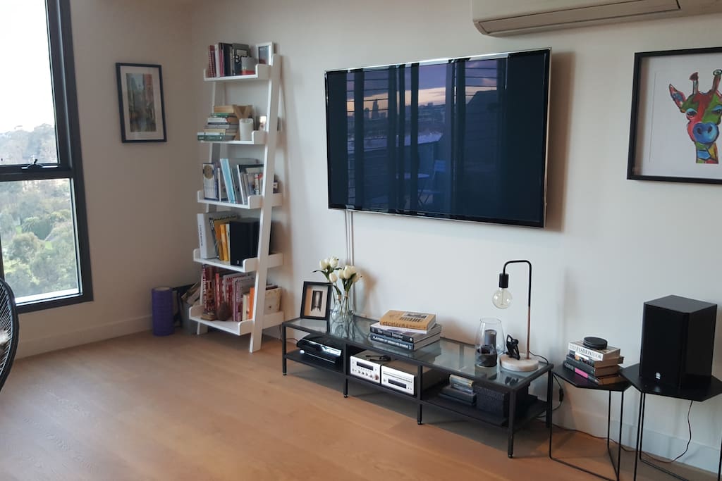 Living room with 60" TV, sound system and playstation