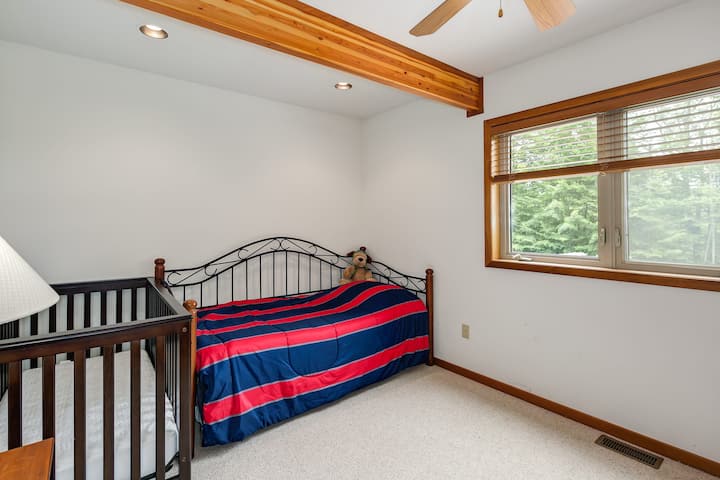 Another bedroom on the main floor, with trundle bed and full-sized crib.