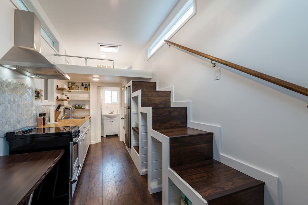 Stairls with storage underneath them leading up to the sleeping loft
